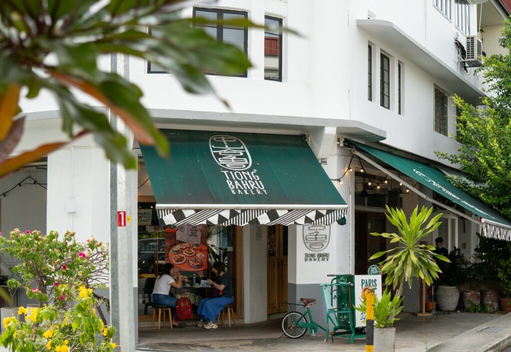 A street corner with a store front and green awnings