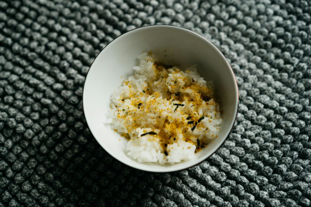 a white bowl filled with rice on top of a table