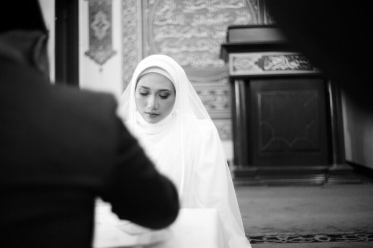 A woman in a white veil standing next to a man