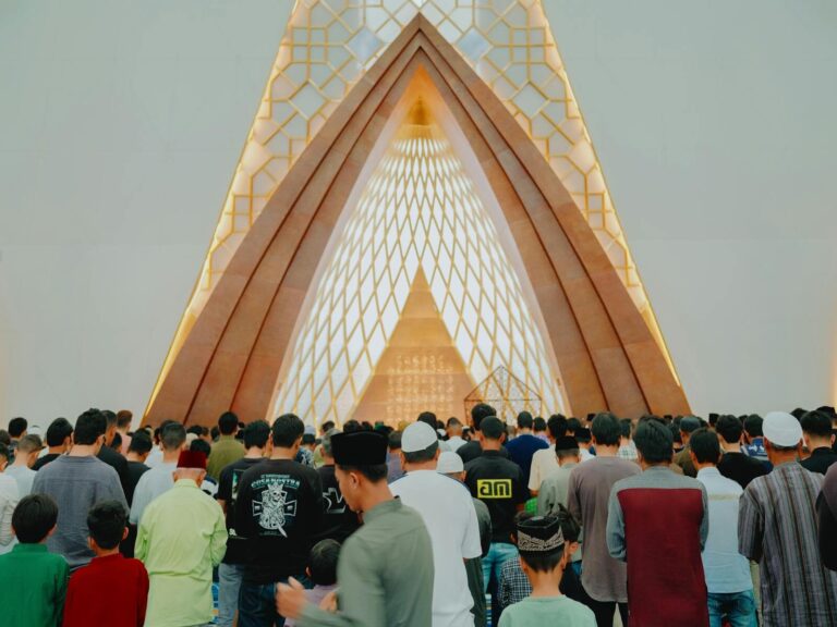 A group of Muslims gathered for prayer inside a modern architectural mosque in Jawa Barat, Indonesia.