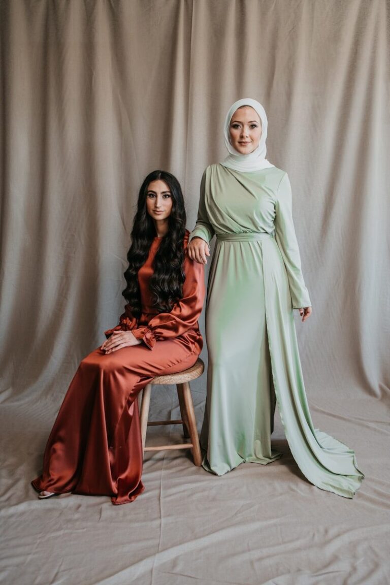 a woman sitting next to a woman in a green dress