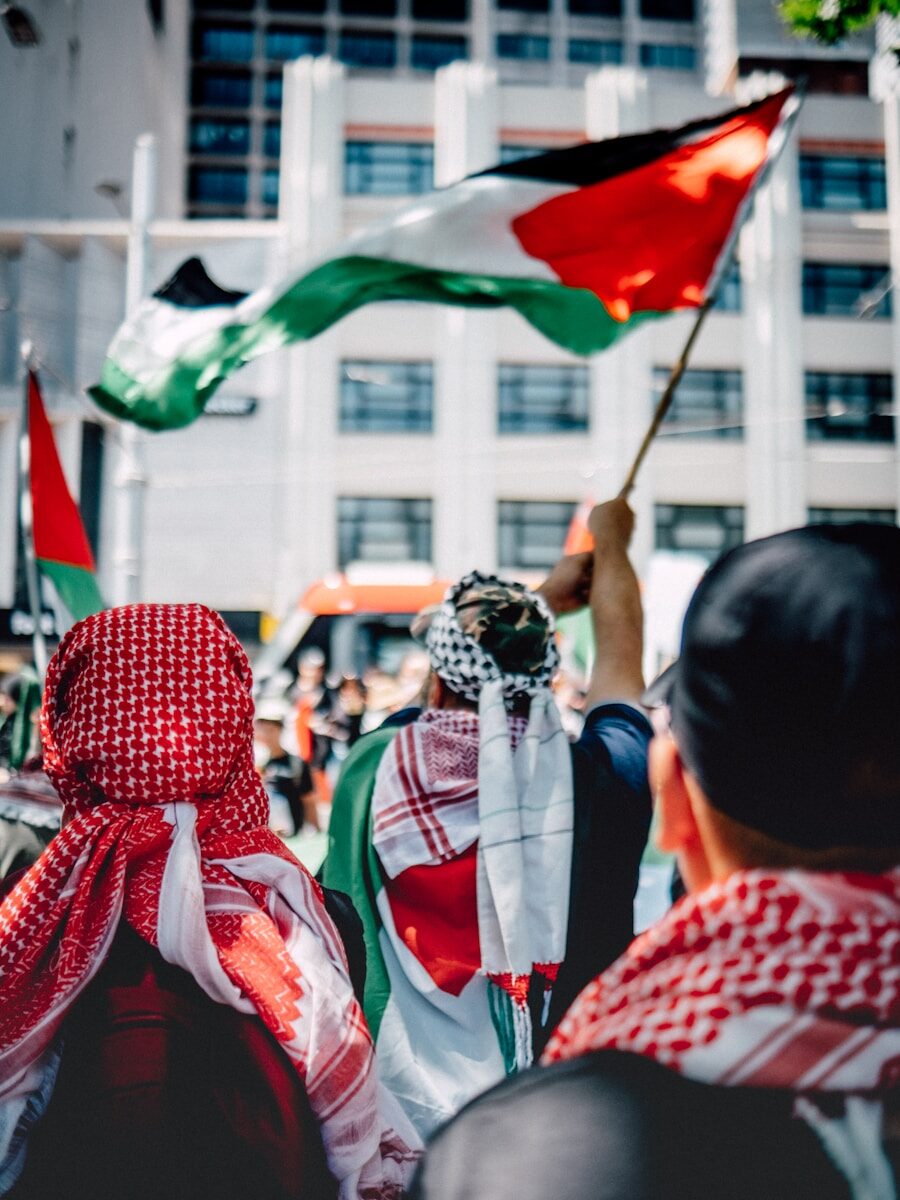 a group of people holding flags in front of a building