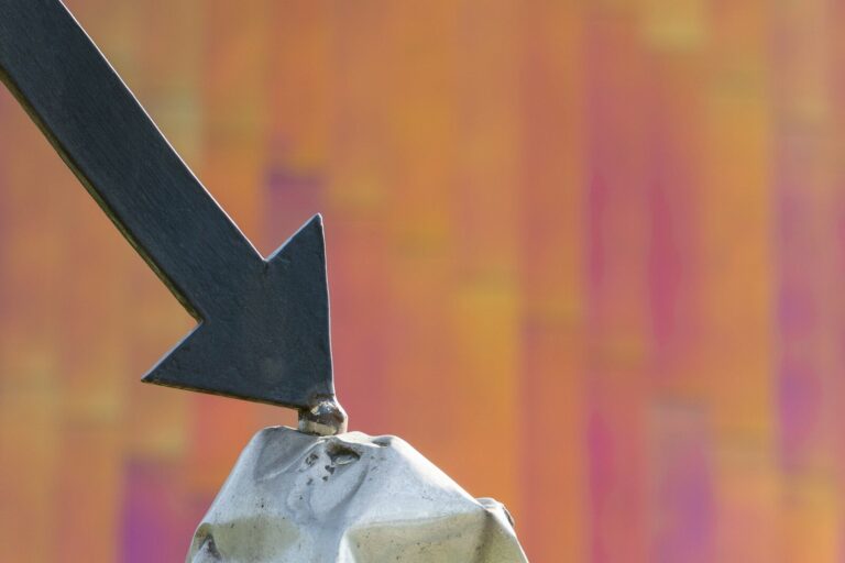 a close up of a metal object with an arrow on it