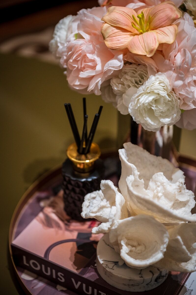A decorative arrangement with flowers and coral pieces.