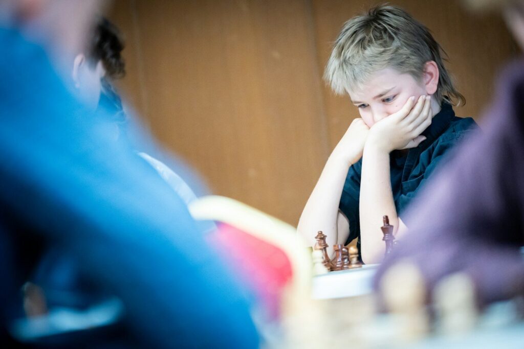 Young person concentrating while playing chess