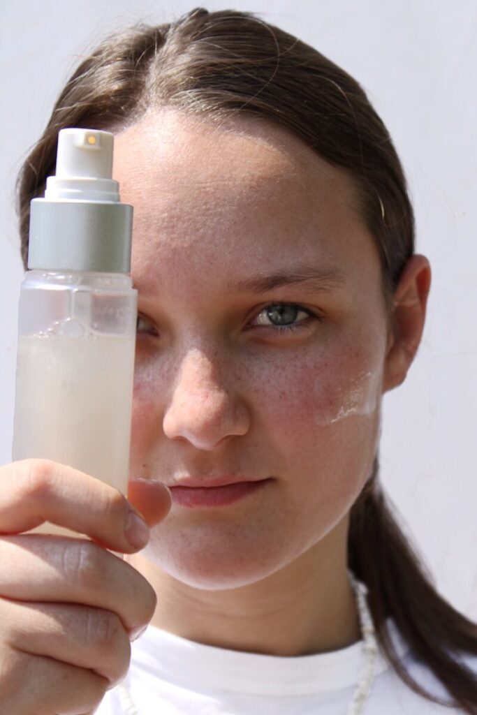 a woman holding a bottle