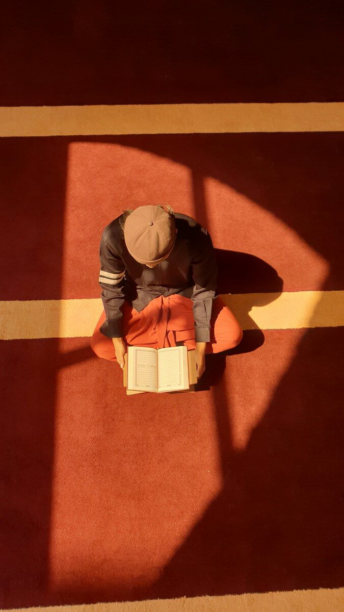 A person sitting on the floor reading a book