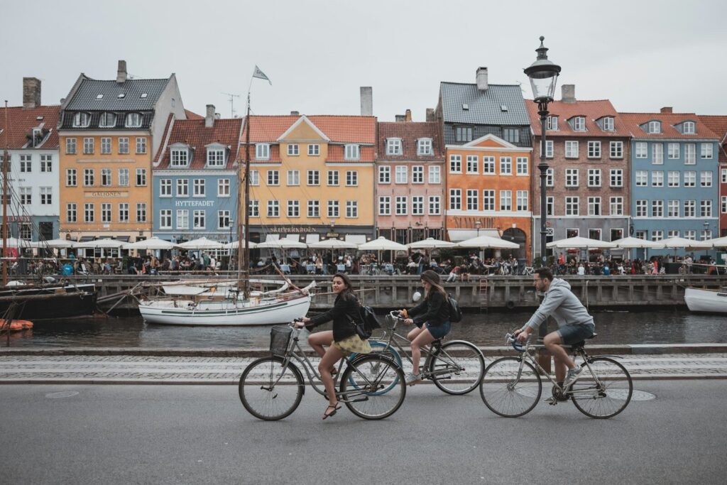 three people riding bicycles