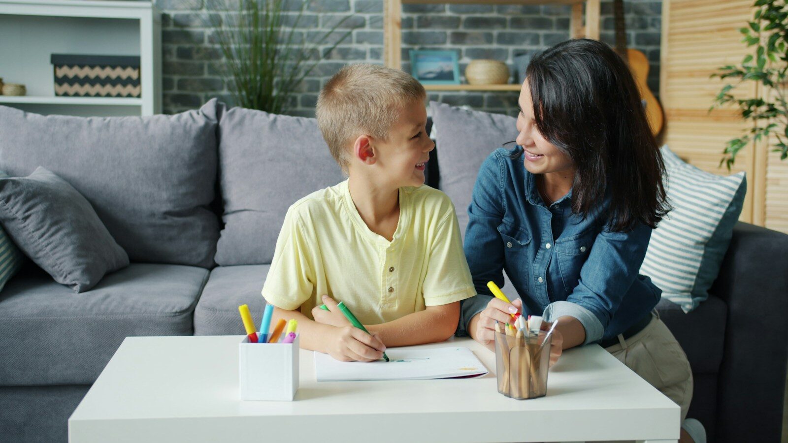 Mother and son drawing at a table together