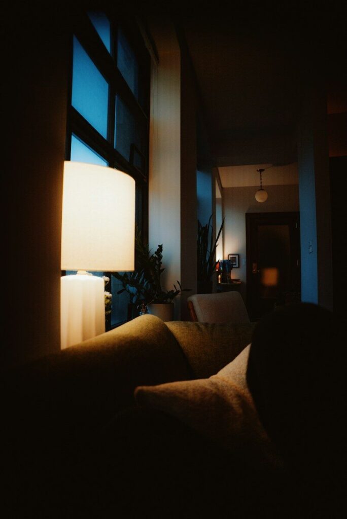 a living room filled with furniture and a lamp