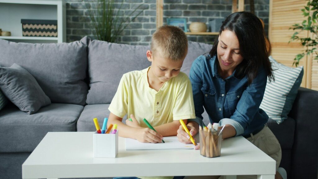 Mother and son drawing together at a table