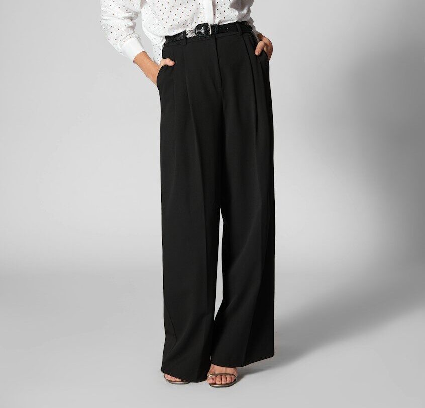 Woman in white shirt and black wide-leg pants