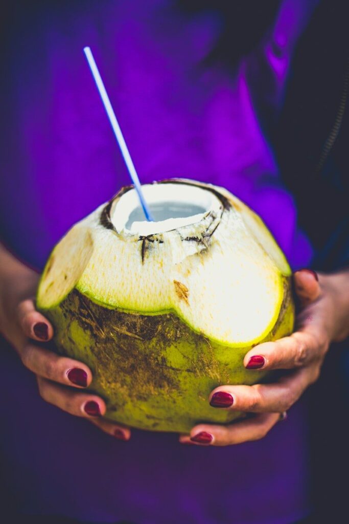 person holding coconut juice