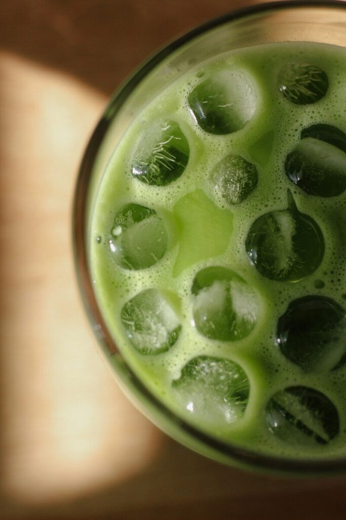 A refreshing green iced drink with ice cubes